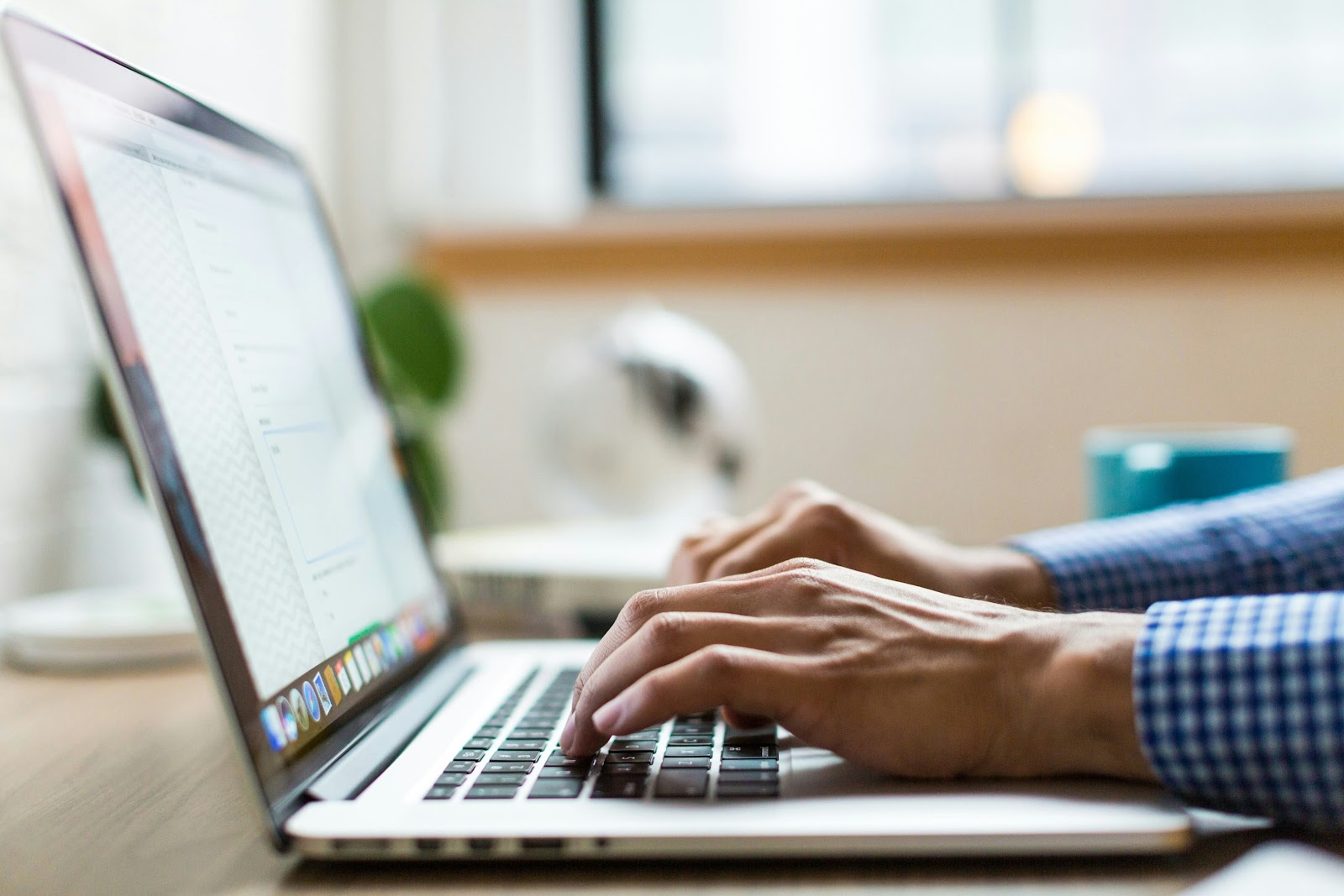 man typing on a laptop