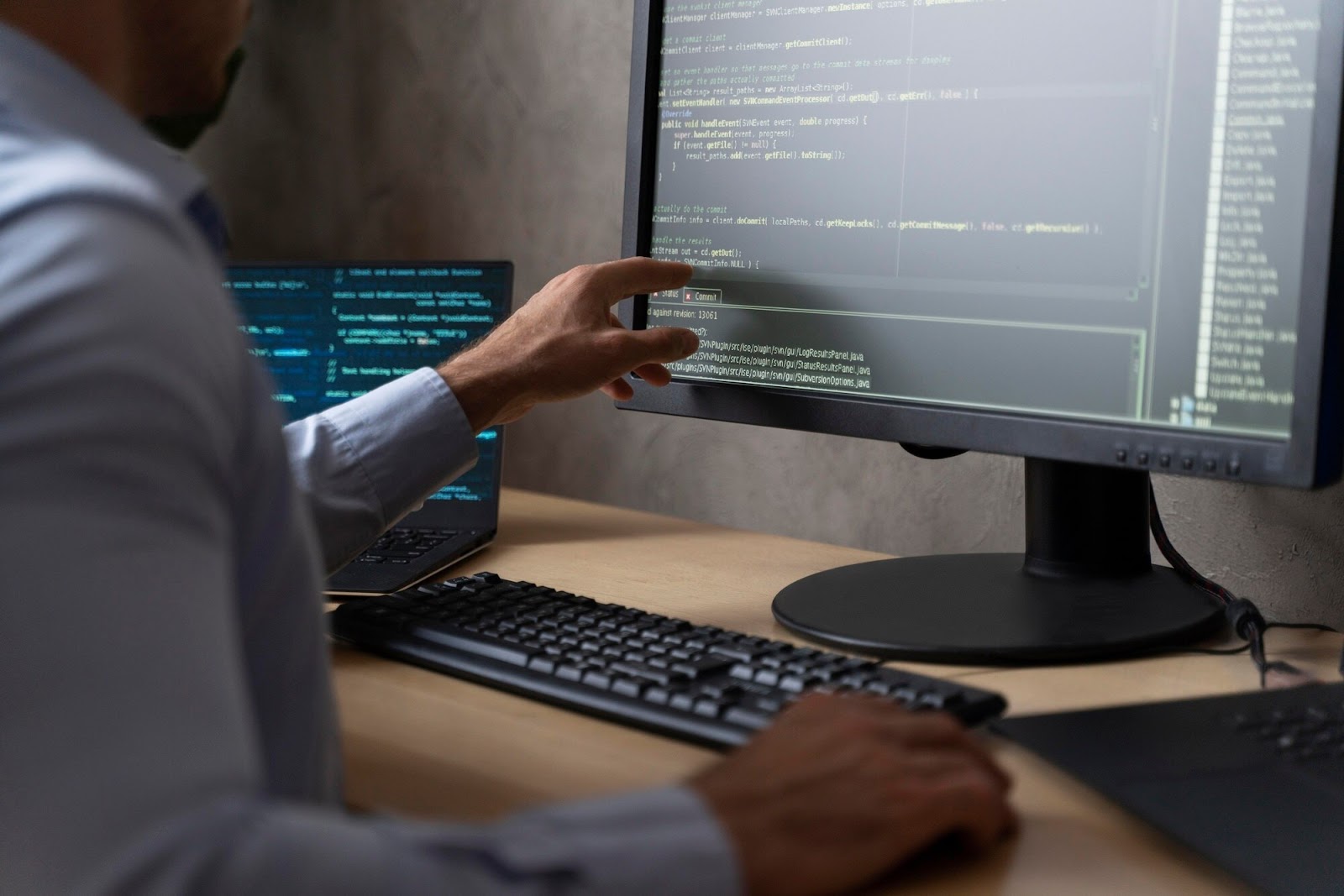 Man pointing to computer code