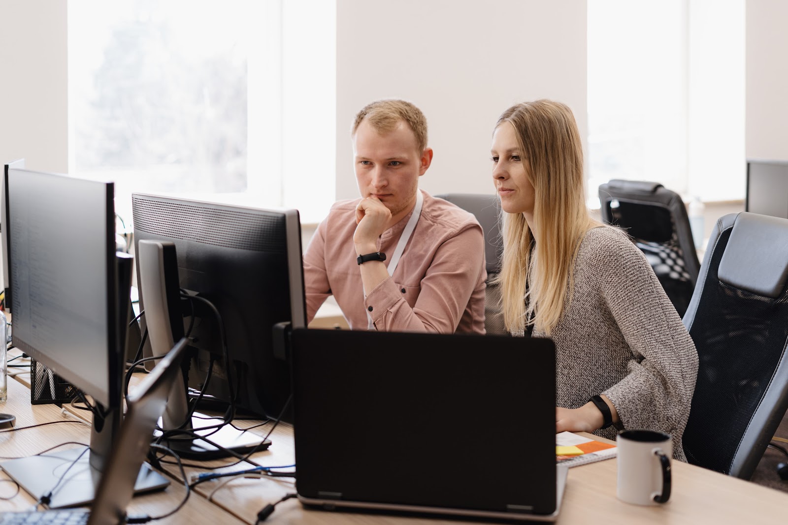 man and woman looking at a computer screen